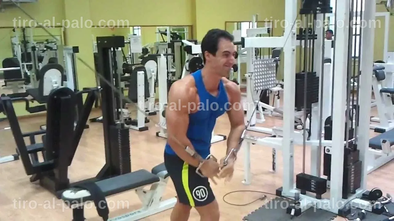 Entrenamiento de tonificación con cruces de poleas, mostrando su efectividad para el pecho.